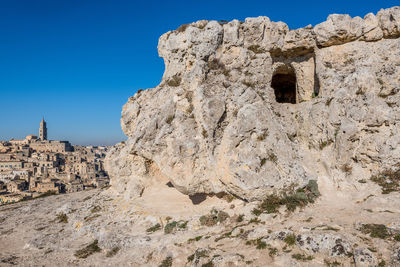 Rock formation against clear blue sky at sassi di matera