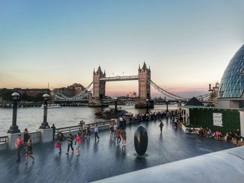 Group of people on bridge over river