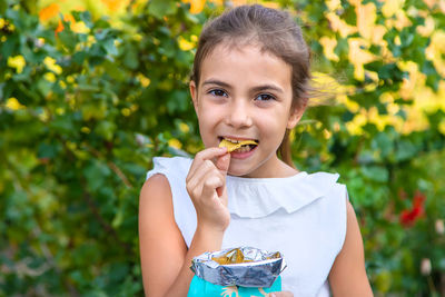 Portrait of girl eating potato chip