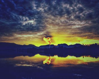 Scenic view of lake against sky at sunset