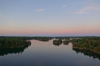 Scenic view of lake against sky at sunset