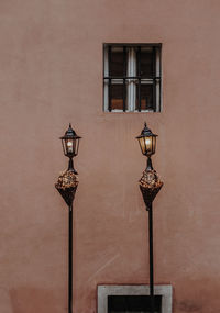 Low angle view of street light against building