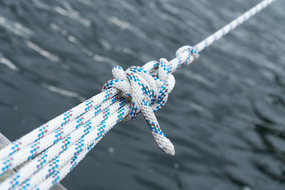 High angle view of ropes tied over sea