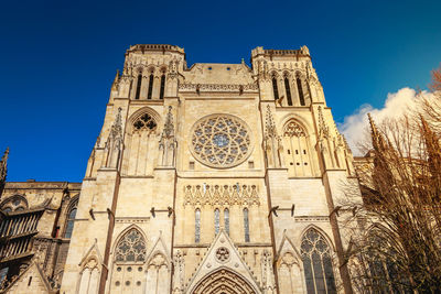 Low angle view of historical building against blue sky