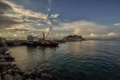 Sailboats on sea against sky during sunset