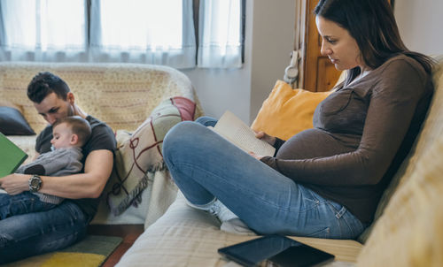Parents with son sitting in living room at home