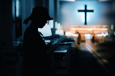 Side view of a silhouette man using smart phone