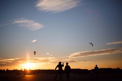 Silhouette of people at sunset