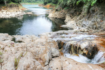 Scenic view of river flowing through rocks