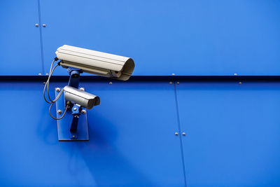 Close-up of security camera on metal wall