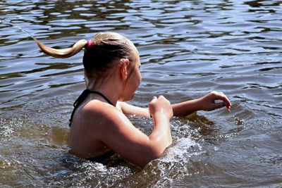 Side view of girl swimming in lake