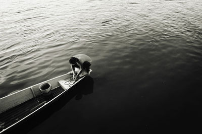 High angle view of man on boat moored in lake