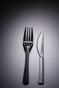 High angle view of plastic fork and table knife