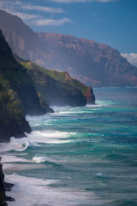 Scenic view of sea and mountains against sky