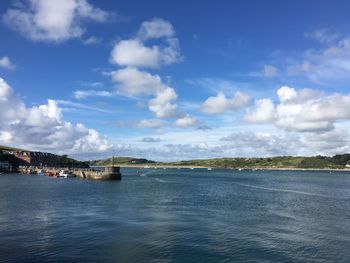 Scenic view of river against cloudy sky