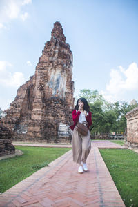 Full length of young woman standing in temple