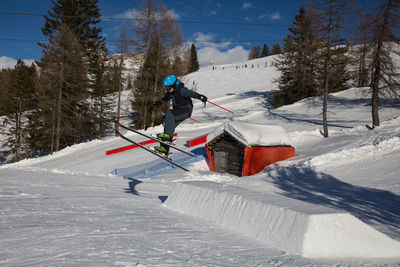 Person skiing on snow against mountain range