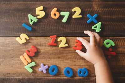 Low section of person with toys on floor