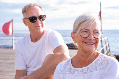 Portrait of smiling friends at beach