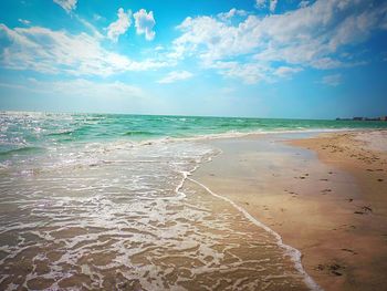 View of beach against cloudy sky