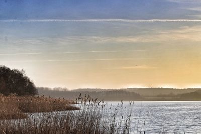 Scenic view of lake against sky during sunset