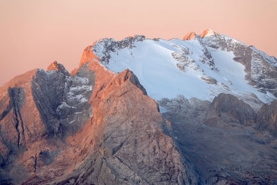 Scenic view of snowcapped mountains against sky during sunset