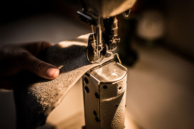 Close-up of person working at machine