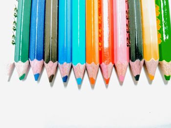 Close-up of colored pencils on white background