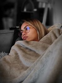 Portrait of woman resting on sofa at home