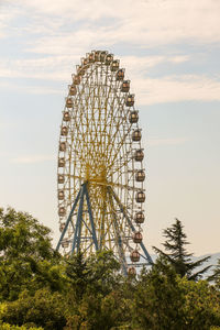 Low angle view of ferris wheel against sky