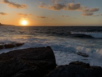 Scenic view of sea against sky during sunset