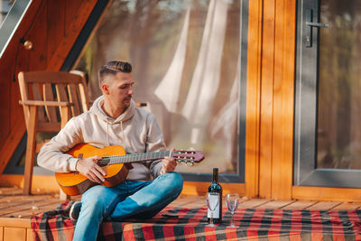 Full length of man playing guitar