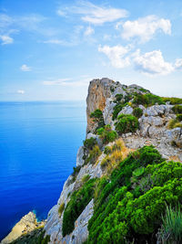 Rock formations by sea against sky