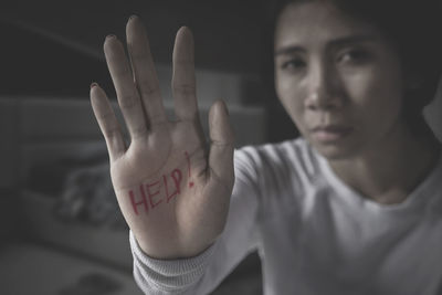 Portrait of victim showing help text on palm