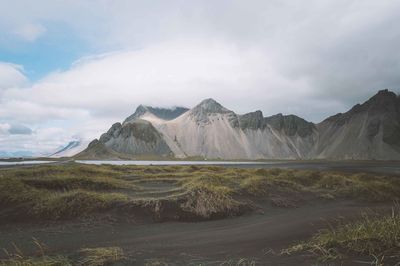 View of mountain range against cloudy sky