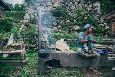 Man sitting on seat in yard