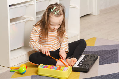 Child at home learning to play musical instruments. leisure and education at home