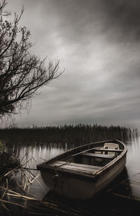 Boats moored in lake against sky