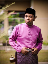 Man in traditional clothes standing outdoors