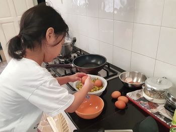 Woman holding ice cream at home