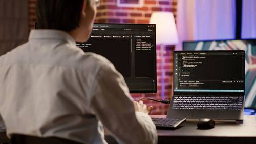 Rear view of man working in office