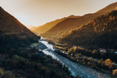 Scenic view of river amidst mountains against sky