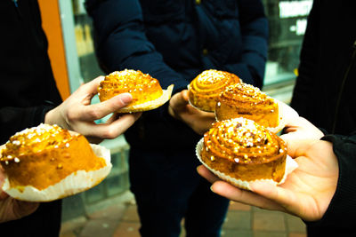 People holding sweet buns