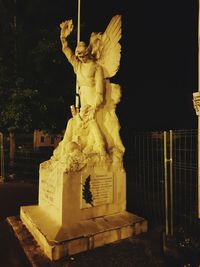 Statue against sky at night