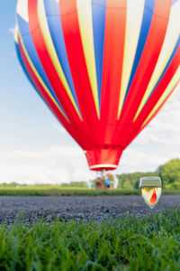 Hot air balloon flying over field