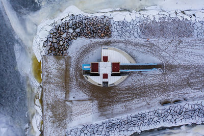 Close-up of snow covered road by building