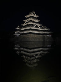 Illuminated building against sky at night