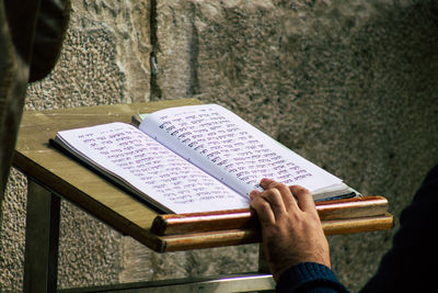 High angle view of hand holding book