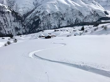 Snow covered landscape against mountain