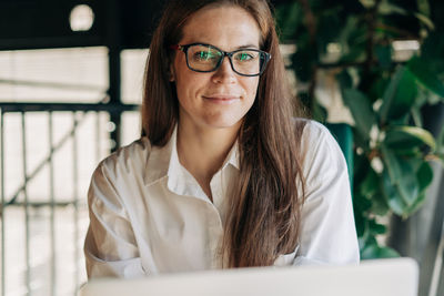 Portrait of young woman using mobile phone